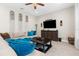 Comfortable living room with a large sofa and decoratively ornamented walls at 32924 Estate Garden Dr, Wesley Chapel, FL 33545