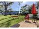 Relaxing backyard featuring a hammock, chair, and patio set, perfect for outdoor enjoyment at 5820 43Rd N Ter # 1406, St Petersburg, FL 33709
