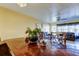 Bright dining room with wood table, pendant lighting, and open access to the living room at 5820 43Rd N Ter # 1406, St Petersburg, FL 33709