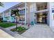 Charming condo building with neat landscaping, sidewalk and an American flag waving at 5820 43Rd N Ter # 1406, St Petersburg, FL 33709