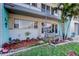 Charming condo featuring a nicely landscaped front porch with seating area at 5820 43Rd N Ter # 1406, St Petersburg, FL 33709