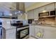 Modern kitchen with stainless steel appliances, granite countertops, stylish cabinets, and tile backsplash at 5820 43Rd N Ter # 1406, St Petersburg, FL 33709