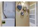 Convenient laundry closet with stacked washer and dryer unit and decorative heart mirrors at 5820 43Rd N Ter # 1406, St Petersburg, FL 33709