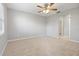 Open layout bedroom with plush carpet and ceiling fan ready for furnishings at 2593 Peak St, Palm Harbor, FL 34683