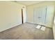 Bedroom featuring neutral walls, carpet, a closet, and a window providing sunlight at 8926 Forge Breeze Loop, Wesley Chapel, FL 33545