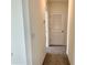 Hallway with carpet flooring, leading to various rooms within the house at 8926 Forge Breeze Loop, Wesley Chapel, FL 33545