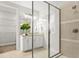 Modern bathroom featuring a glass-enclosed shower and a vanity with granite countertops and contemporary fixtures at 13929 Lake Fishhawk Dr, Lithia, FL 33547