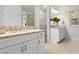 Well-lit bathroom with double vanities and granite countertops at 13929 Lake Fishhawk Dr, Lithia, FL 33547