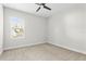 A neutral colored bedroom with a ceiling fan and a window at 13929 Lake Fishhawk Dr, Lithia, FL 33547
