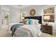 This bedroom features a plush bed, stylish decor, and plenty of natural light from the two large windows at 13929 Lake Fishhawk Dr, Lithia, FL 33547