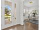 Welcoming foyer with glass doors, leading to a home office with a desk and stylish decor at 13929 Lake Fishhawk Dr, Lithia, FL 33547