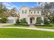 Charming two-story home with a well-manicured lawn, mature trees, and a detached garage at 13929 Lake Fishhawk Dr, Lithia, FL 33547