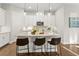 Bright kitchen with stainless appliances, sleek white cabinets, island, and stylish pendant lighting at 13929 Lake Fishhawk Dr, Lithia, FL 33547
