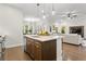 Spacious kitchen island with counter seating offers views into the bright and airy living room at 13929 Lake Fishhawk Dr, Lithia, FL 33547