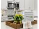 Bright kitchen featuring modern appliances, a mosaic backsplash, and stylish home staging decor at 13929 Lake Fishhawk Dr, Lithia, FL 33547