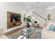 Bright living room featuring a stylish media center, a cozy seating arrangement, and lots of natural light at 13929 Lake Fishhawk Dr, Lithia, FL 33547