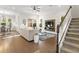 Bright living room with hardwood floors, modern furniture, and a staircase leading to the upper level at 13929 Lake Fishhawk Dr, Lithia, FL 33547
