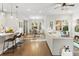 Open-concept living room flows into dining area, featuring modern furnishings and lots of natural light at 13929 Lake Fishhawk Dr, Lithia, FL 33547