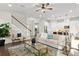 Comfortable living room with stairs, a glass coffee table, and open concept to the kitchen at 13929 Lake Fishhawk Dr, Lithia, FL 33547