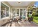 Covered patio with comfortable seating, perfect for outdoor relaxation and enjoying the peaceful backyard at 13929 Lake Fishhawk Dr, Lithia, FL 33547