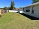 Spacious backyard with a well-maintained lawn, white fence and large shade tree offering outdoor living at 418 Henderson Ave, Seffner, FL 33584
