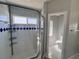 Bright bathroom with glass shower door, neutral walls, and view of toilet at 418 Henderson Ave, Seffner, FL 33584