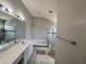 Well-lit bathroom with a large mirror, vanity, and a luxurious bathtub with a shower at 418 Henderson Ave, Seffner, FL 33584