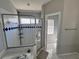 Elegant bathroom featuring a glass-enclosed shower and a separate toilet area for added privacy at 418 Henderson Ave, Seffner, FL 33584