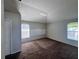 Spacious bedroom features plush carpet, two windows, and wall decor at 418 Henderson Ave, Seffner, FL 33584