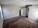 Bright bedroom with neutral walls, comfortable carpet, and direct access to the bathroom at 418 Henderson Ave, Seffner, FL 33584