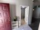 View of the home's entry and adjacent laundry room, featuring light gray walls and tile floors at 418 Henderson Ave, Seffner, FL 33584