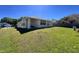 Single-story home with a spacious yard, well-maintained lawn, and charming curb appeal on a sunny day at 418 Henderson Ave, Seffner, FL 33584