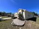 Charming single-Gathering home featuring neutral stucco, decorative rock landscaping, and mature shrubs enhancing curb appeal at 418 Henderson Ave, Seffner, FL 33584