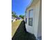 Cream-colored house with manicured lawn and garden beds lining the foundation, enhancing curb appeal at 418 Henderson Ave, Seffner, FL 33584