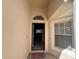 Inviting front entrance with arched transom window and welcome mat at 418 Henderson Ave, Seffner, FL 33584