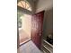 The red front door with an adjacent welcome mat creates an inviting entrance at 418 Henderson Ave, Seffner, FL 33584