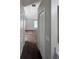 Hallway view looking into room with neutral brown carpet and two storage closets at 418 Henderson Ave, Seffner, FL 33584