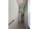 Hallway view features neutral walls, tiled floors, and standard doors at 418 Henderson Ave, Seffner, FL 33584