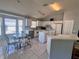 Bright kitchen with white cabinets, a functional island, and a cozy breakfast nook at 418 Henderson Ave, Seffner, FL 33584