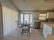 Charming kitchen featuring tile flooring, a dining nook, and bright natural light at 418 Henderson Ave, Seffner, FL 33584