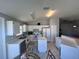 White kitchen featuring an island, white cabinets, and modern appliances at 418 Henderson Ave, Seffner, FL 33584
