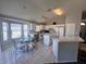 Bright kitchen with white cabinets, a functional island, and a cozy breakfast nook at 418 Henderson Ave, Seffner, FL 33584