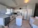 Bright kitchen with white cabinets and a functional center island at 418 Henderson Ave, Seffner, FL 33584
