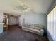 Neutral living room featuring a ceiling fan and ample natural light at 418 Henderson Ave, Seffner, FL 33584