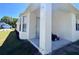 Covered patio with a concrete slab and support beams, offers an outdoor space for relaxation and storage at 418 Henderson Ave, Seffner, FL 33584
