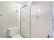 Shower in bathroom with easy-to-clean white tiles and a sliding glass door at 12200 Vonn Rd # 1209, Largo, FL 33774