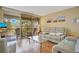 Cozy living room with wood floors, comfortable seating, and sliding doors to the outside at 12200 Vonn Rd # 1209, Largo, FL 33774