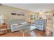 Comfortable living room with multiple seating options and open access to kitchen and dining areas at 12200 Vonn Rd # 1209, Largo, FL 33774