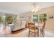 Open living space featuring hardwood floors, living room seating, dining table, and outdoor access at 12200 Vonn Rd # 1209, Largo, FL 33774