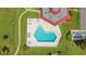 Overhead shot of a geometric-shaped swimming pool with lounge chairs and well-maintained landscaping at 12200 Vonn Rd # 1209, Largo, FL 33774
